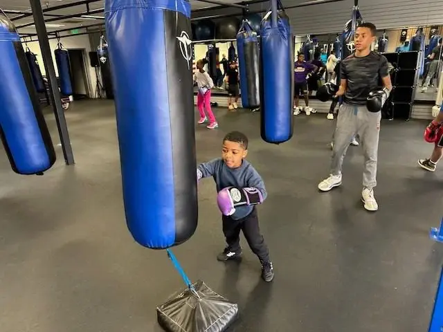 Young boy boxing in gym class
