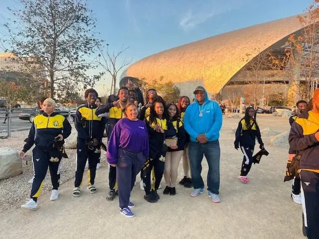 Group posing outside modern building